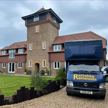 Reliable Removals crew carrying furniture during a house move