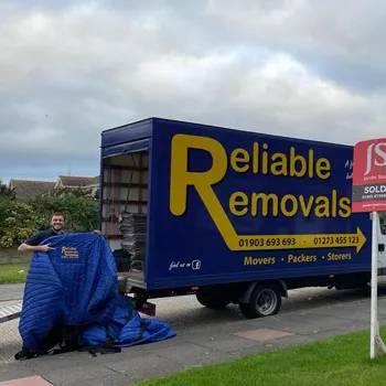 Reliable Removals team loading boxes into a removal van