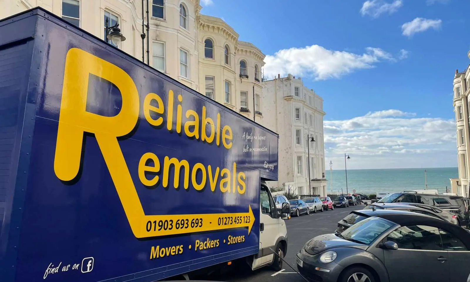 Reliable Removals branded van parked on the Worthing seafront